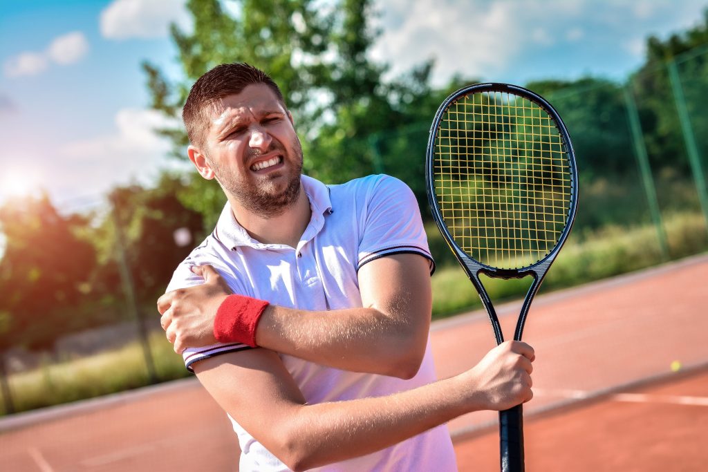 A tennis player with shoulder joint pain on a clay court, joint health