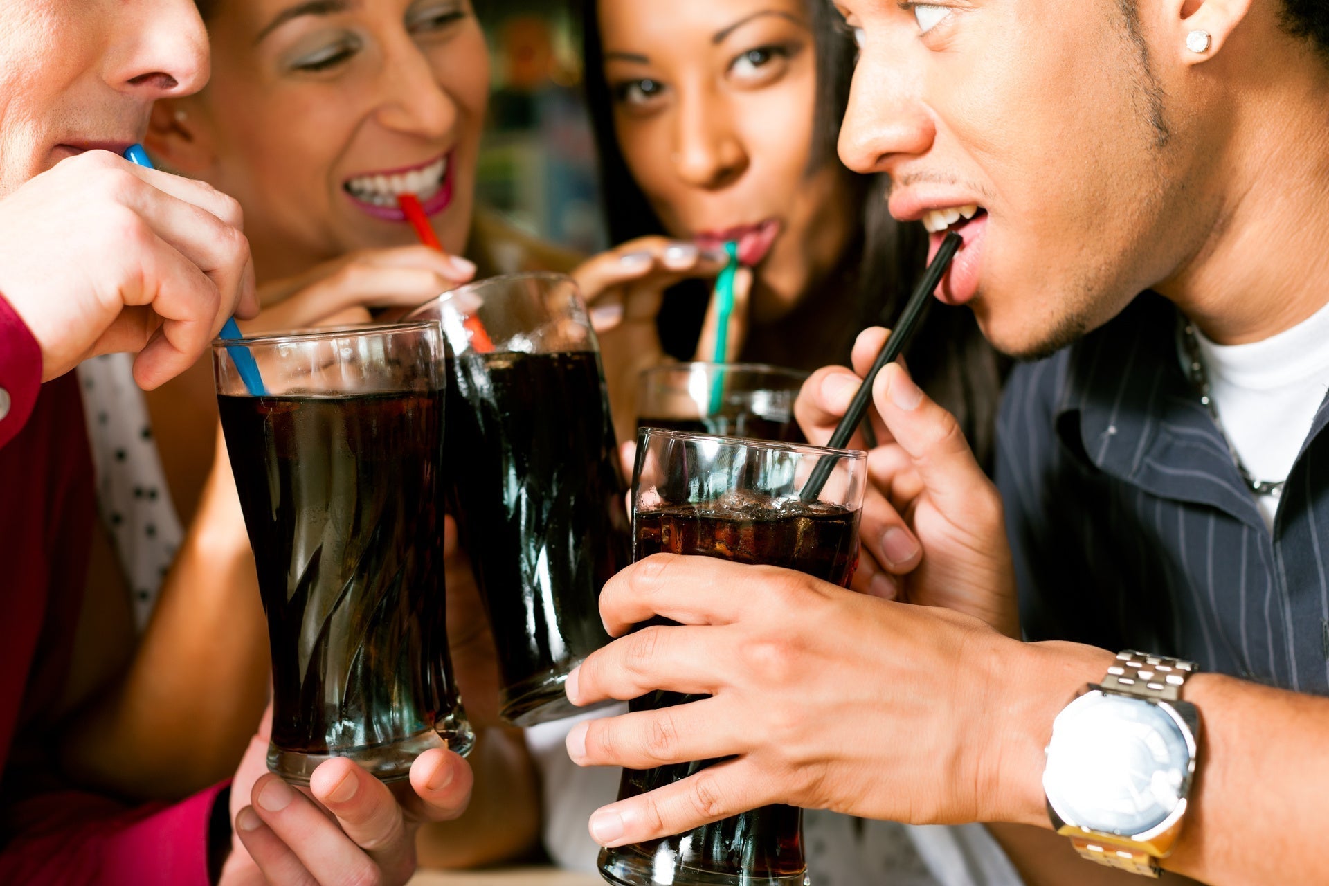 Friends drinking soda together, one of the worst foods for brain health