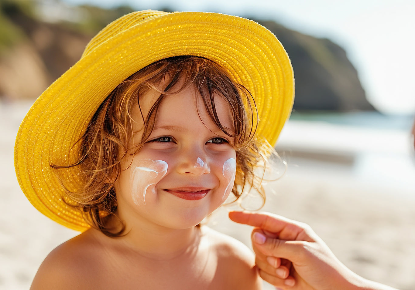 Smiling child with sunscreen on cheeks for sun safety.