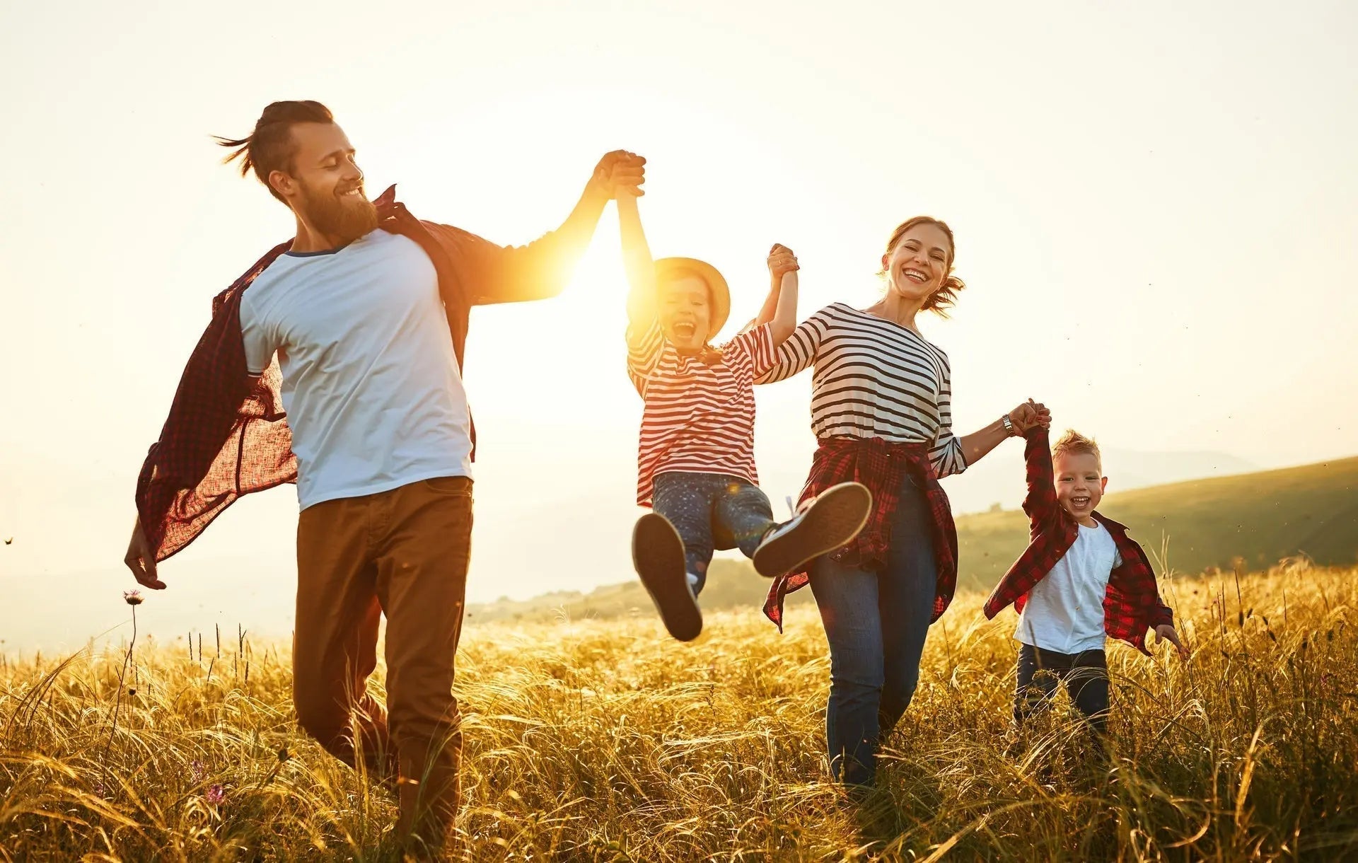 Father, mother, son, and daughter walking outside in the sunshine getting Vitamin D3 - what to know