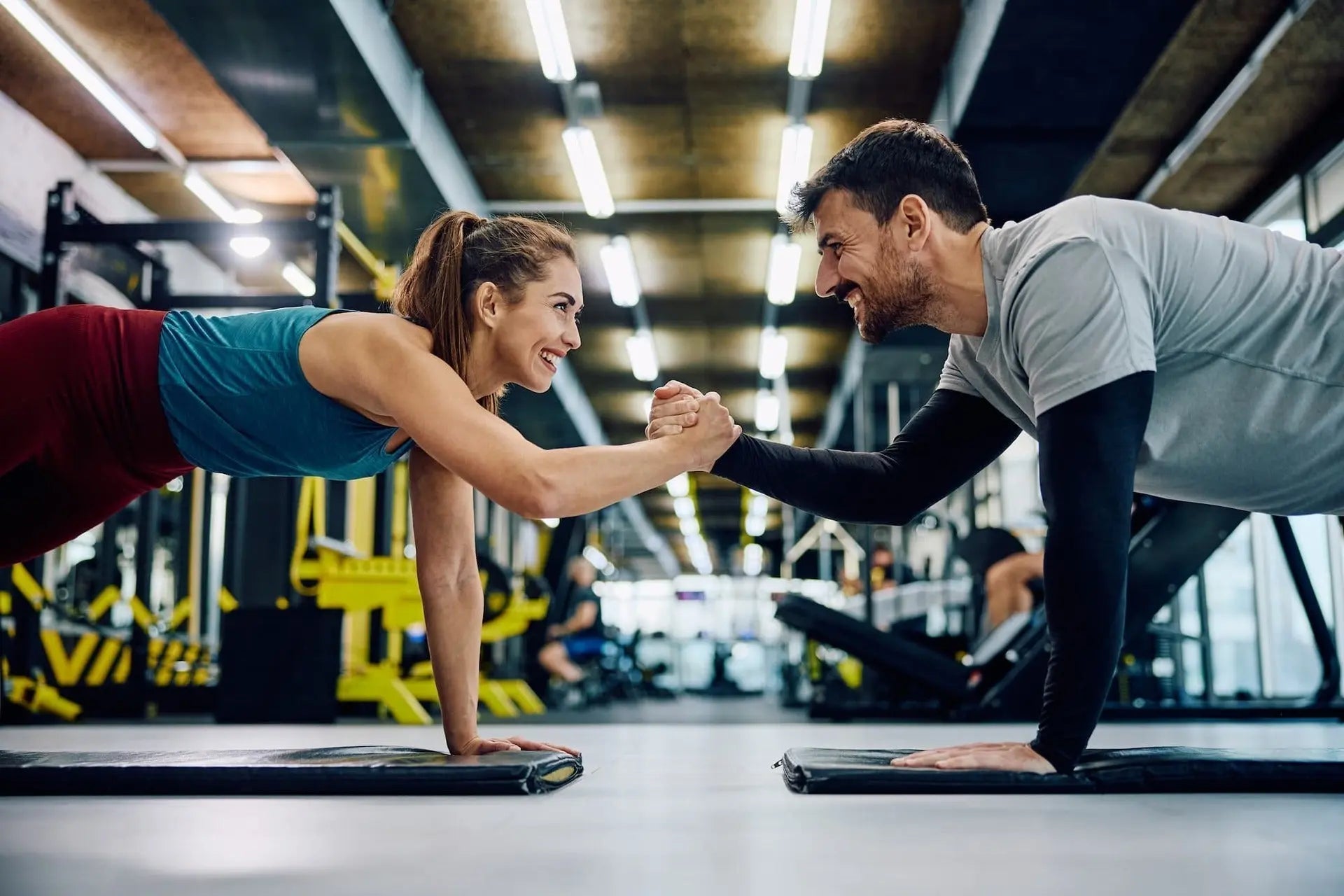 Young couple working out in the gym together dementia prevention starts in your 30s